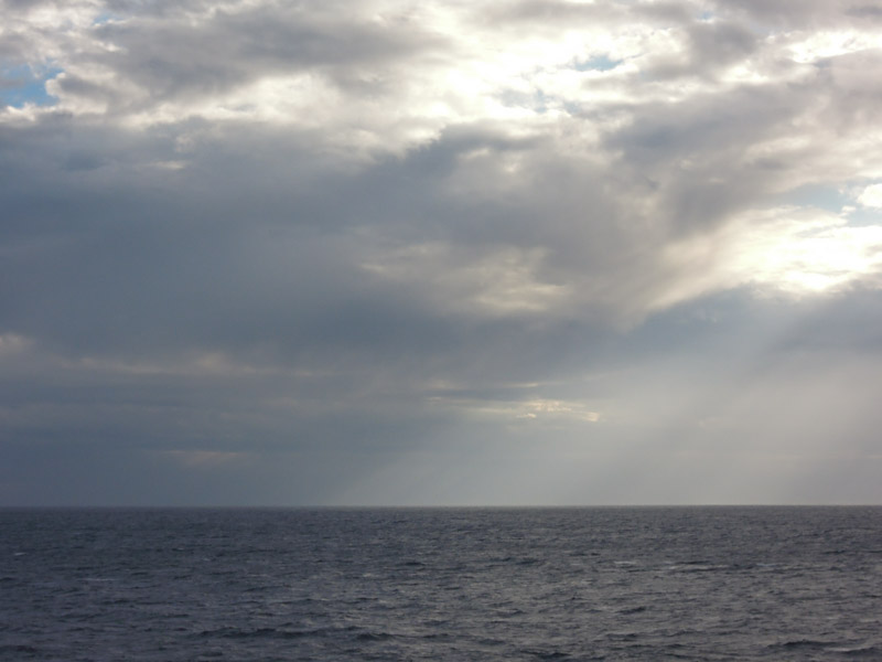 Photo of a partially grey sky and the ocean